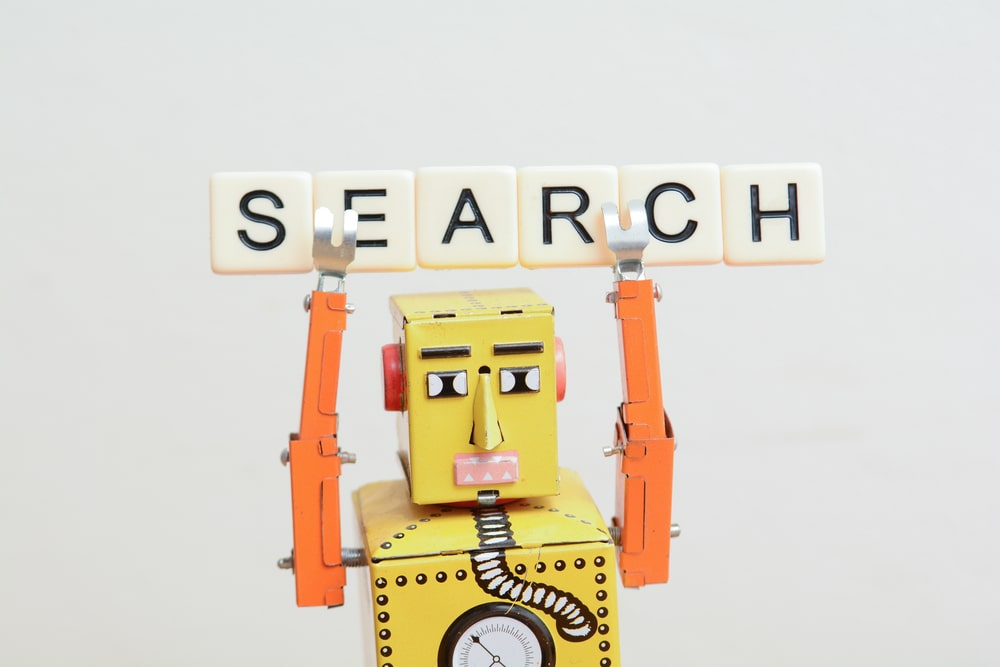 robot holding search sign